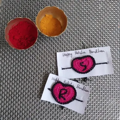 Custom initial rakhis for Raksha Bandhan. These heart-shaped rakhis with letters 'S' and 'R' are a personal way to celebrate the sibling bond.