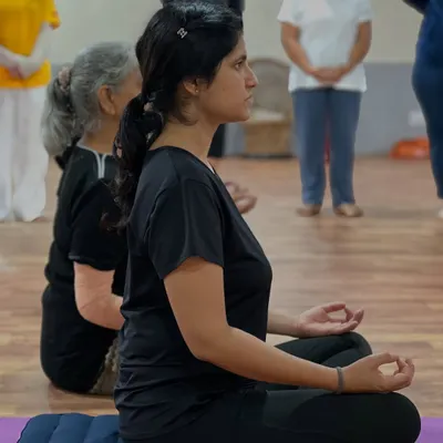 A student sits in a steady, comfortable posture for pranayama. An erect spine is essential for deep diaphragmatic breathing and the upward flow of energy.