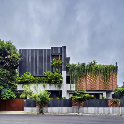 Project 58 is a home where the landscape takes over, making the architecture porous. Here, a facade of custom terracotta blocks and cascading greenery creates a living skin that breathes, connecting the home to its garden and the street.