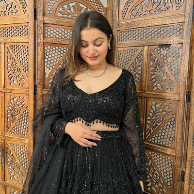 A close-up of the stunning black sequined lehenga. The intricate beadwork on the blouse and the full-sleeve design make it a glamorous choice for any evening event.