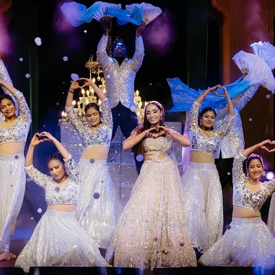 A beautiful formation for a bride and her squad. We used flowing fans and heart-hand gestures to create a visually soft and romantic performance, backed by professional dancers for a fuller look.