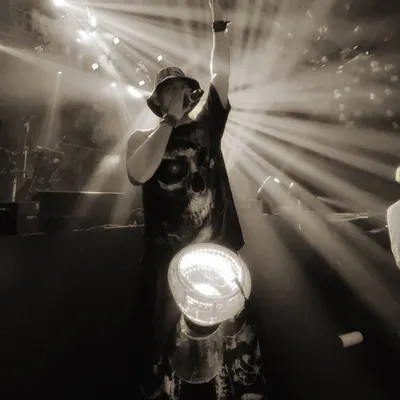 This is me in my element. A powerful moment captured on stage, with dramatic backlighting and my LED drum, commanding the attention of a massive audience. This is the iconic energy I bring.