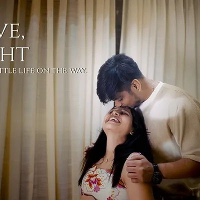 Love, light, and a little life on the way. This image is filled with pure, unposed joy, captured in the familiar comfort of the couple's home.