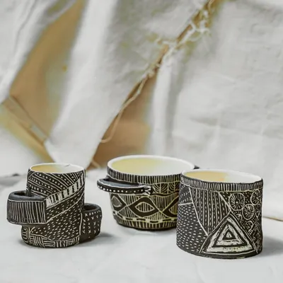This trio of hand-built cups showcases the incredible detail and texture our Foundation course students learn to create. The intricate sgraffito patterns demonstrate a mastery of surface decoration and a unique artistic voice.
