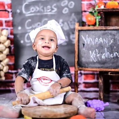 This little chef is all smiles and ready to get messy in his personalized kitchen. I love capturing these moments of pretend play, where their imagination truly shines.