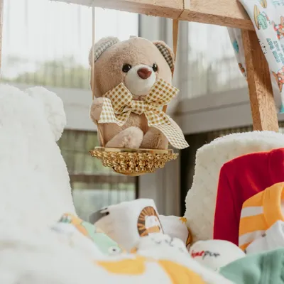 A close-up of the adorable teddy bear detail in our luxury newborn baby hamper. It's these small, thoughtful touches that make our gifts truly special.