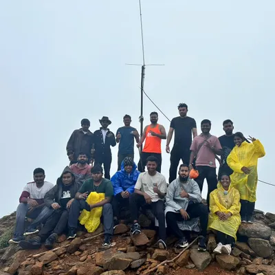 Our trekking family at a misty summit. This group conquered one of the beautiful monsoon treks in the Western Ghats, sharing ponchos and smiles.