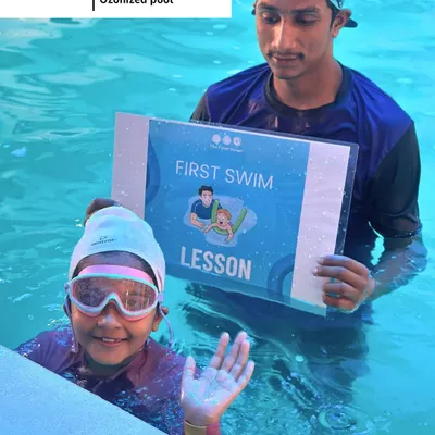 Celebrating a huge milestone. This young swimmer is all smiles after her very first swim lesson, ready for many more adventures in the water.