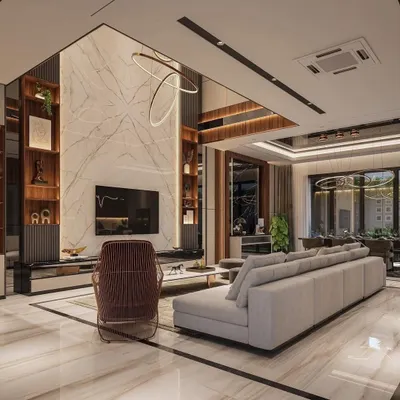 This double-height living room is the epitome of grandeur. We used a floor-to-ceiling marble-finish panel for the TV wall, flanked by wooden shelving units, to draw the eye upward and emphasize the scale of the space. The design creates a luxurious, open, and impressive area for hosting and relaxation.