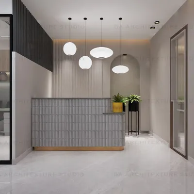 The reception area for a transportation company, featuring a fluted desk, modern pendant lights, and an arched mirror, creating a stylish first impression.