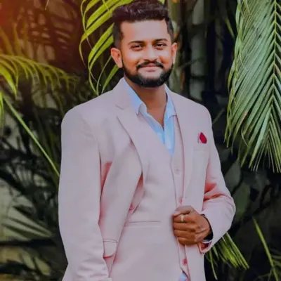 A partner looking sharp and confident in our custom-made pink three-piece suit. We can create or rent suits in various colors to perfectly complement your gown and the theme of your photoshoot.