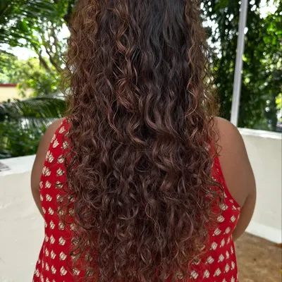 Once you embrace your curls, you'll never go back. Here's a look at a beautiful curly hair transformation, showing off the defined, healthy coils from the back.