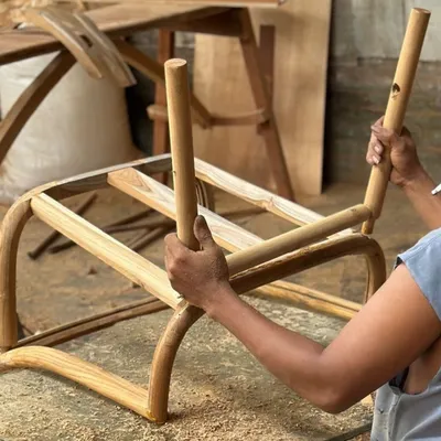 Here, one of my skilled artisans is assembling the frame of a chair. This image captures the hands-on approach and precision that goes into every piece of furniture we create.