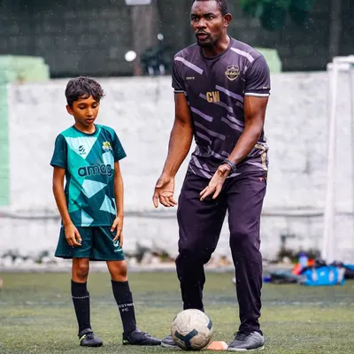 A coach provides one-on-one guidance to a young player. We believe in personalized attention to help every child master the fundamentals of ball control and technique.