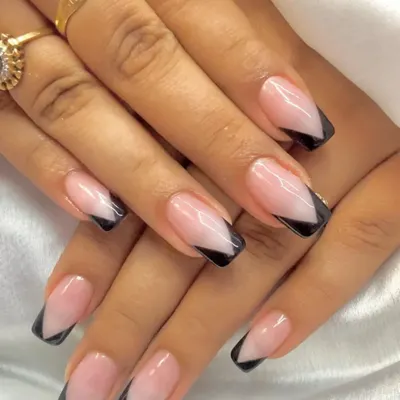 A modern take on a classic. This sharp, black V-cut French tip design on a square-shaped nail is clean, bold, and effortlessly chic.