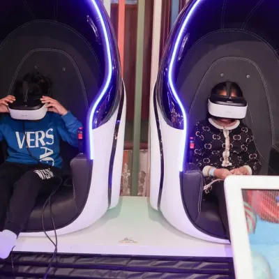 Our futuristic VR gaming chairs are always trending! Two kids are buckled in and ready to explore amazing virtual worlds side-by-side.