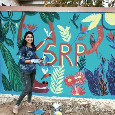 I'm so proud of this vibrant jungle themed mural we completed for the Karnataka State Reserve Police campus. The bright blue background is filled with colourful birds, flowers, and tropical leaves, creating a positive and lively environment.
