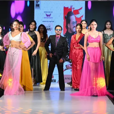 The grand finale of my show at the "Fashion Runway of India" event. I'm on stage with all the models, showcasing a colorful and diverse collection of my designs.