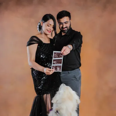 This little one is already so loved, and their furry big brother can't wait to meet them. We love including pets in your pregnancy announcement photos.
