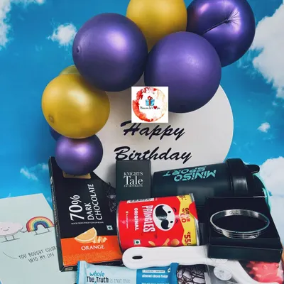A stylish birthday hamper for him, featuring a mini balloon arrangement, a Miniso sport shaker, Pringles, dark chocolate, and a sleek bracelet.