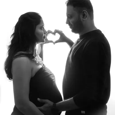 A beautiful silhouette shot where the couple forms a heart with their hands. In black and white, this image becomes a timeless symbol of their love.