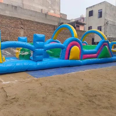 A long inflatable obstacle course designed for races and team-building events. It features a series of hurdles, tunnels, and climbing sections.