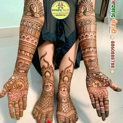 A stunning full bridal set covering arms and feet with matching peacock and traditional motifs. The consistent design language creates a truly grand and cohesive look for the bride.