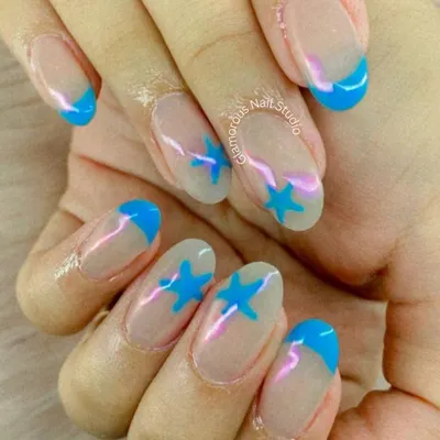 A playful take on a classic. This design features a clean, natural base with bright sky-blue French tips and matching star accents for a fun and youthful vibe.