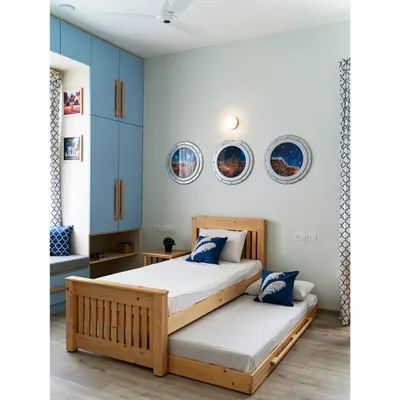 A room for a young space enthusiast! This bedroom in #TheRaghuvaniHome features our solid pine trundle bed and custom wall art depicting nebula views from spaceship portals, creating a cosmic haven for dreams and adventures.