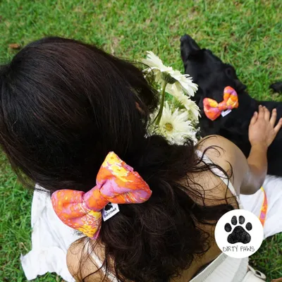 A perfect twinning moment. This overhead shot shows me wearing a bow hair clip that matches the bow on my dog's collar. It's my favorite way to coordinate with my best friend.