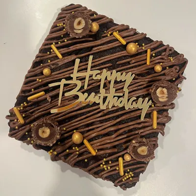 What's better than a slice of brownie? A whole brownie cake. This is a slab of my fudgiest eggless brownie, decorated with chocolate drizzle, sprinkles, and Ferrero Rocher.