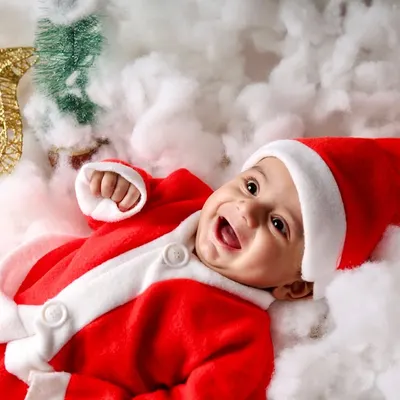 The happiest little Santa. This baby's joyful laugh is the highlight of this Christmas mini-session, surrounded by fluffy white "snow."