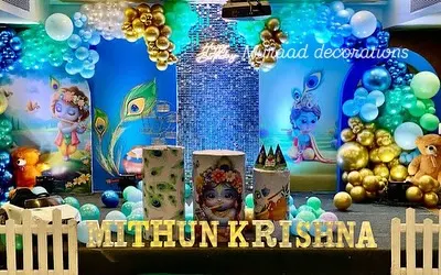 This is a fun and vibrant setup I did for a Krishna-themed birthday party. The decor features peacock feather motifs, character illustrations, and a blue and gold balloon garland to create a divine and playful atmosphere.
