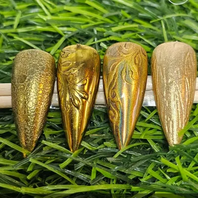 A sampler of chrome variation nail art. This shows how chrome powder can be used to create different textures and patterns, from a reptile-skin effect to embossed floral and abstract designs.