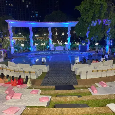 A wide view of the poolside reception stage at Raheja Exotica. We arranged both formal chair seating and casual floor seating with cushions, ensuring all guests had a great view of the main event.