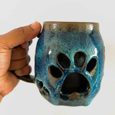 I love how this double-walled paw mug turned out. The paw prints are carved from the outer wall, making it a perfect gift for any dog lover. The deep blue glaze is just beautiful.