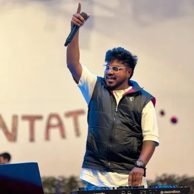 On the mic and hyping up the massive student crowd at Christ University. I love the raw energy of a college fest; it's my job to take it to the next level.