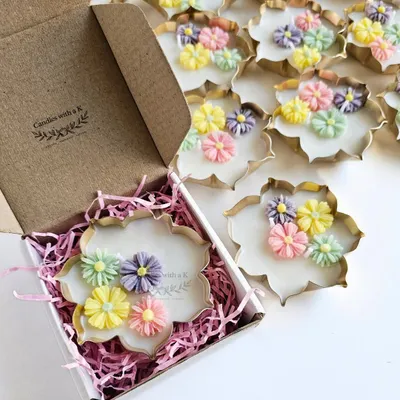 A beautiful Urli candle with pastel daisy flowers being placed in a custom box. This order was for Harini's brand, a perfect example of my white-label work.