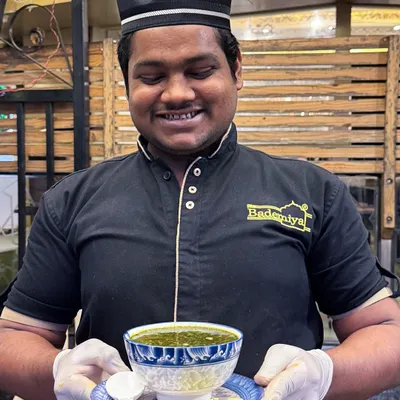 Served with a smile. Our staff proudly presents a bowl of our signature Ramzan soup, a dish made with love and tradition.