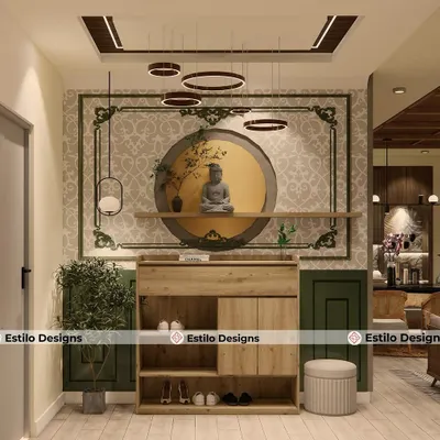 The foyer sets the tone for the entire home, and for this project, I created a serene entrance with a beautiful Buddha statue as the focal point. This space blends traditional Indian motifs with modern lighting and functional shoe storage.
