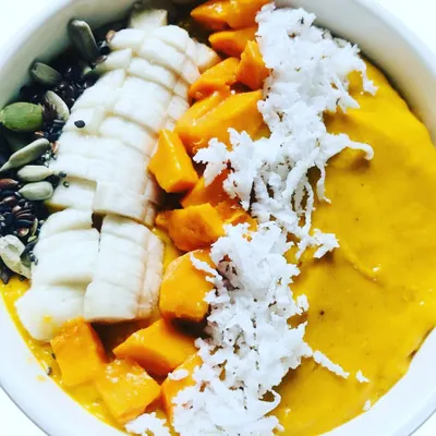 The king of fruits shines in my special Mango Smoothie. Made with mango, dates, and super seeds, and garnished with fresh banana and grated coconut, it's a taste of summer in a bowl.