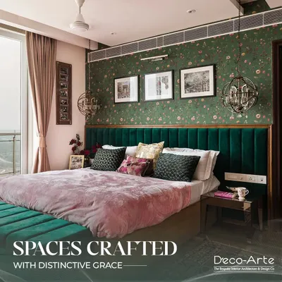 This bedroom is crafted with distinctive grace, featuring a deep green velvet headboard against floral wallpaper. The design creates a luxurious staycation feel, perfect for unwinding in style.