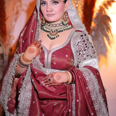 This is the bridal look I created for myself. A classic royal aesthetic with a deep maroon outfit, heavy kundan and emerald jewelry, and a focus on defined, captivating eyes.