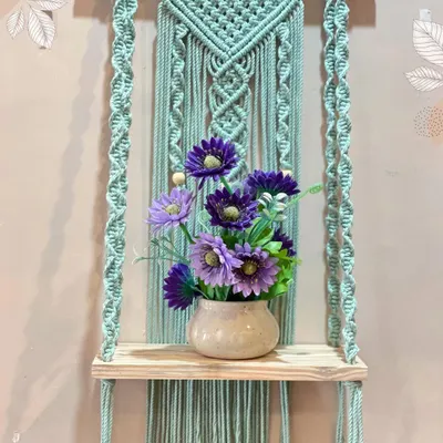 This is one of my most popular shelf designs. The beautiful mint green macrame panel provides a lovely backdrop for the light wood shelf, perfect for holding a vase or small decor items.