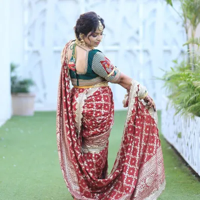A beautiful customer looking radiant in a red bandhani-style Nauvari for her wedding function.