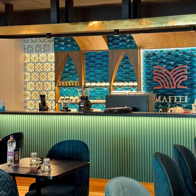 The atmosphere of our restaurant is designed to be warm and inviting. The intricate tilework, custom lighting, and comfortable seating create a sophisticated backdrop for a memorable dining experience, which inspires the quality of our at-home products.