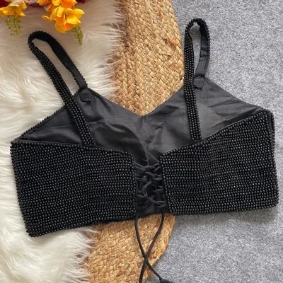 The back view of my black pearl moti spaghetti blouse. This pure silk, padded blouse features a stylish back-open design with a lace-up tie for an adjustable fit.