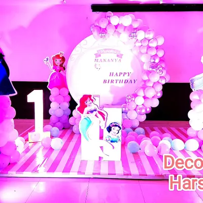 This princess theme party combines characters from different fairy tales like Frozen and The Little Mermaid. I created a full stage with a custom backdrop, multiple character cutouts, and a large marquee number '1' for a truly royal first birthday.