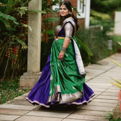 Our beautiful client Shanvi in a stunning Langa Davani. The combination of a green skirt and purple half saree is a classic South Indian choice.