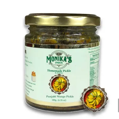 This is my signature Punjabi Mango Pickle, a flavour I grew up with. It's made with raw mangoes, cold-pressed mustard oil, and a robust blend of Punjabi spices. Each bite is a taste of home.